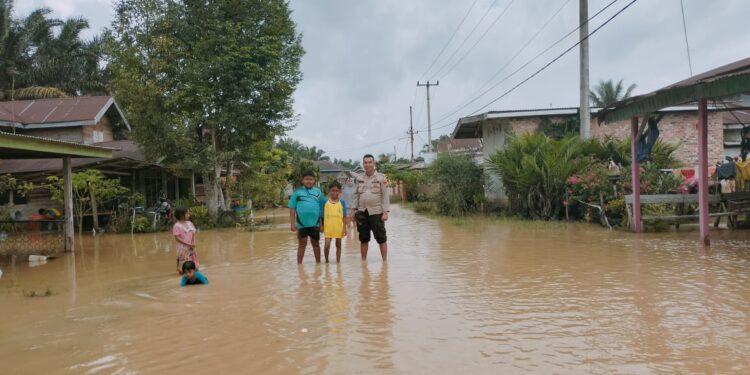 Banjir Mulai Naik di Desa Sahilan Darussalam, Bhabinkamtibmas Himbau Warga Waspada