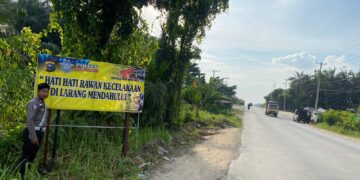 Polsek Pangkalan Kuras Pasang Spanduk dan Sosialisasi Tertib Lalu Lintas di Jalan Lintas Timur