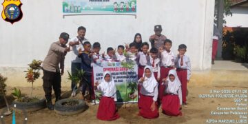 Polisi Bunut Tanam Bibit Pohon Kelengkeng di SDN 006 Desa Petani Pelalawan